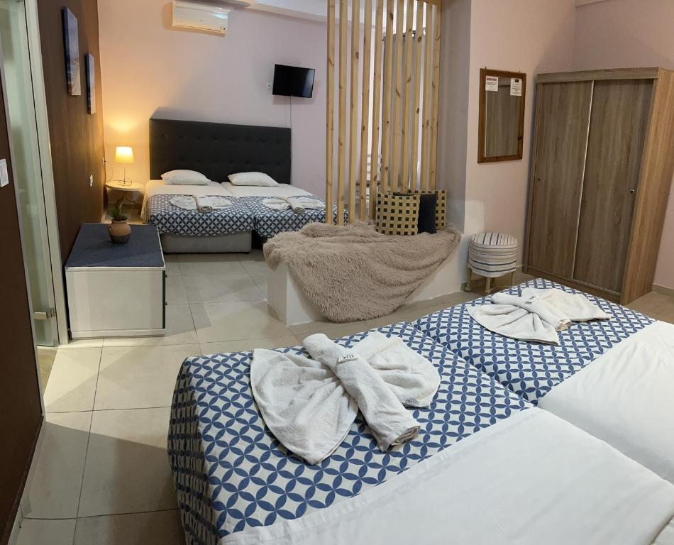 a hotel room with two beds with towels on them at Golden days in Afantou