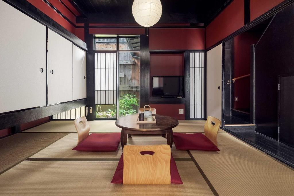 a dining room with a table and chairs at Suo an Machiya House in Kyoto