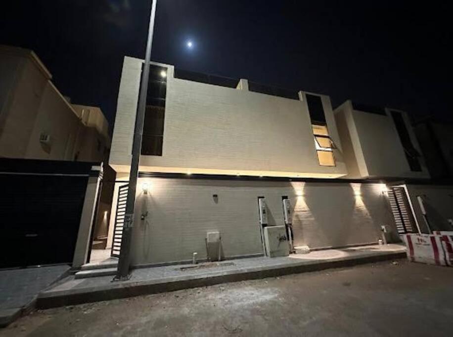 a white building with a street light in front of it at فيلا ساره in Medina