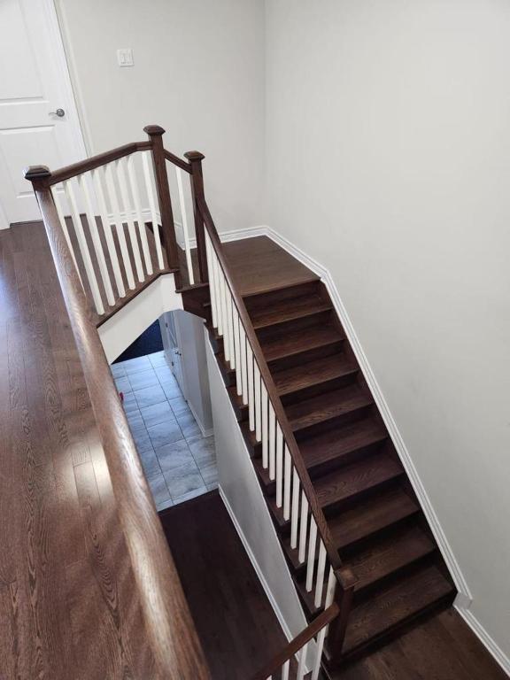 a stairway with a wooden railing and a wooden floor at Stay with Star in Ottawa