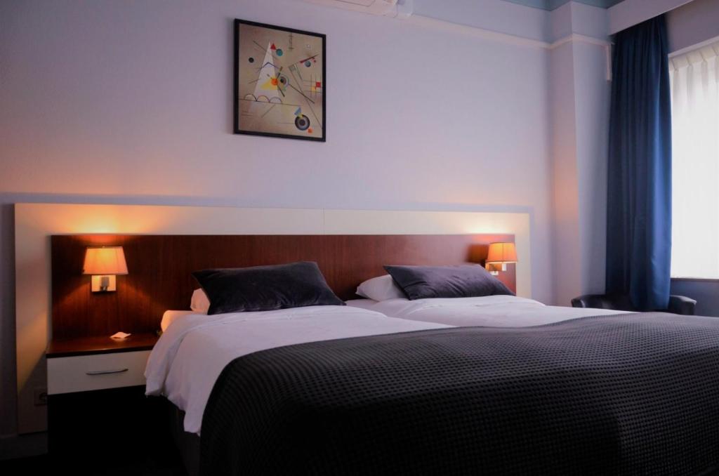 Postel nebo postele na pokoji v ubytování Apollo Hotel