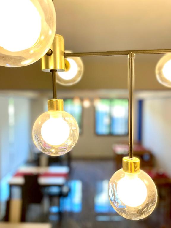 a group of three light bulbs hanging from a ceiling at Marku Palace in Ksamil