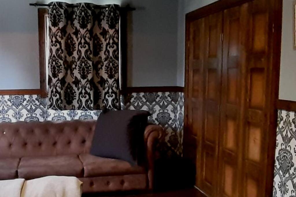 a living room with a couch and a window at Stylish Farm House in Eli Ad