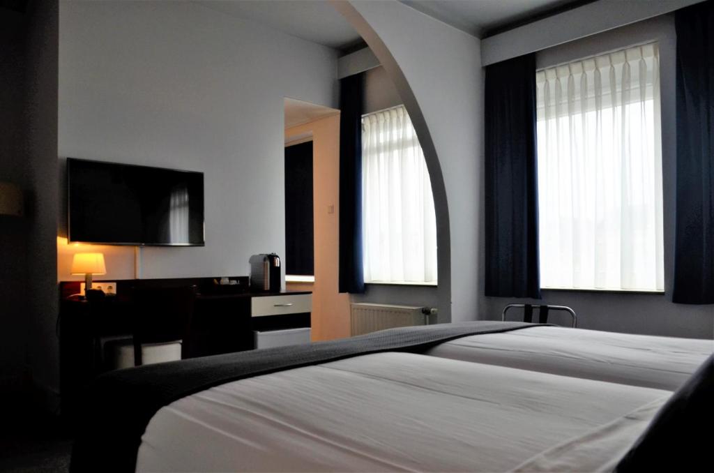 Postel nebo postele na pokoji v ubytování Apollo Hotel