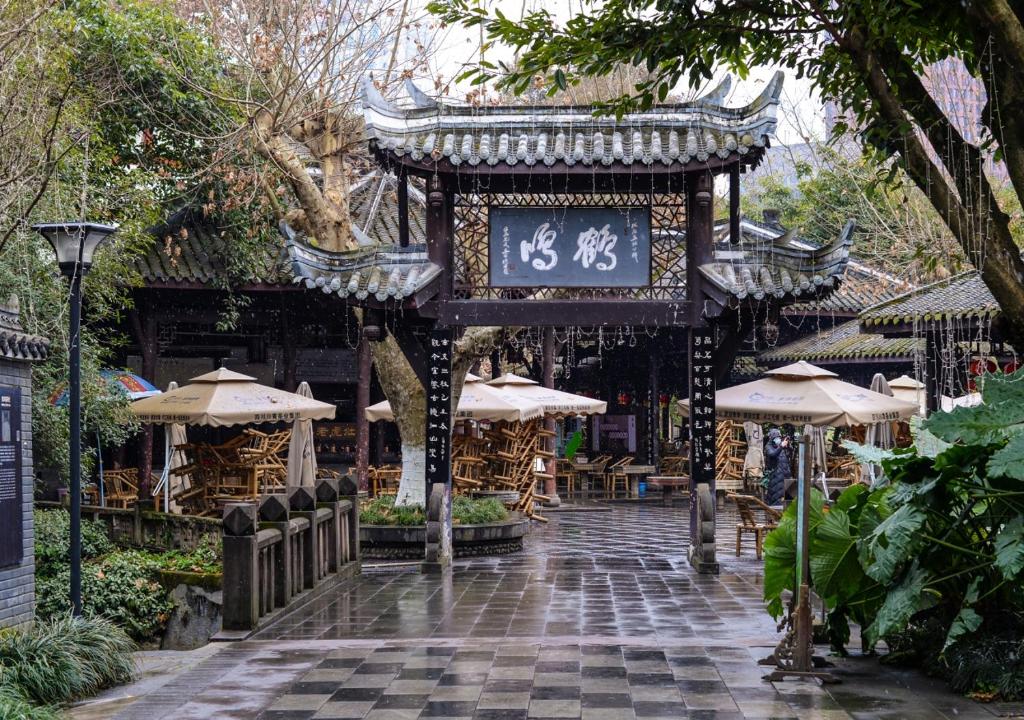 a pagoda with a sign in a garden with umbrellas at Crowne Plaza Chengdu City Center by IHG in Chengdu