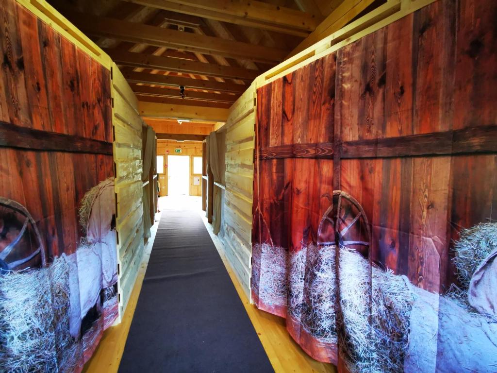 un pasillo con pinturas en las paredes de un edificio en Dormitory and wooden house Beli gaber, en Stari Trg pri Ložu