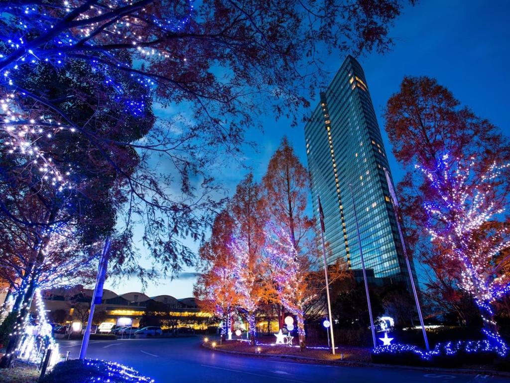 a group of trees decorated with christmas lights at Lake Biwa Otsu Prince Hotel in Otsu