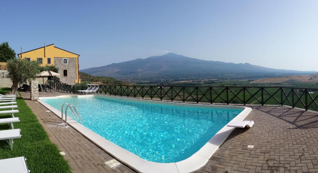a swimming pool with a view of a mountain at Agriturismo Valle dell'Etna in Roccella Valdemone