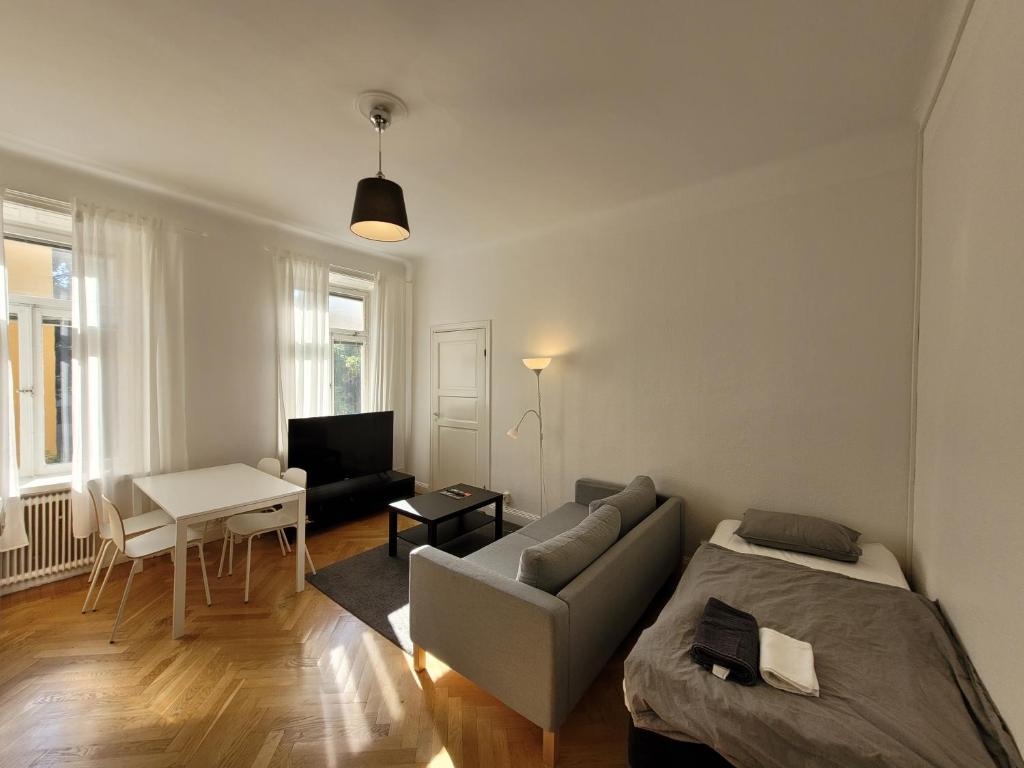 a living room with a couch and a table at Home Inn VMG in Stockholm