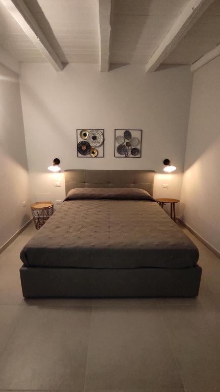 a bedroom with a large bed in a room at Alla Corte di Dionisio in Siracusa