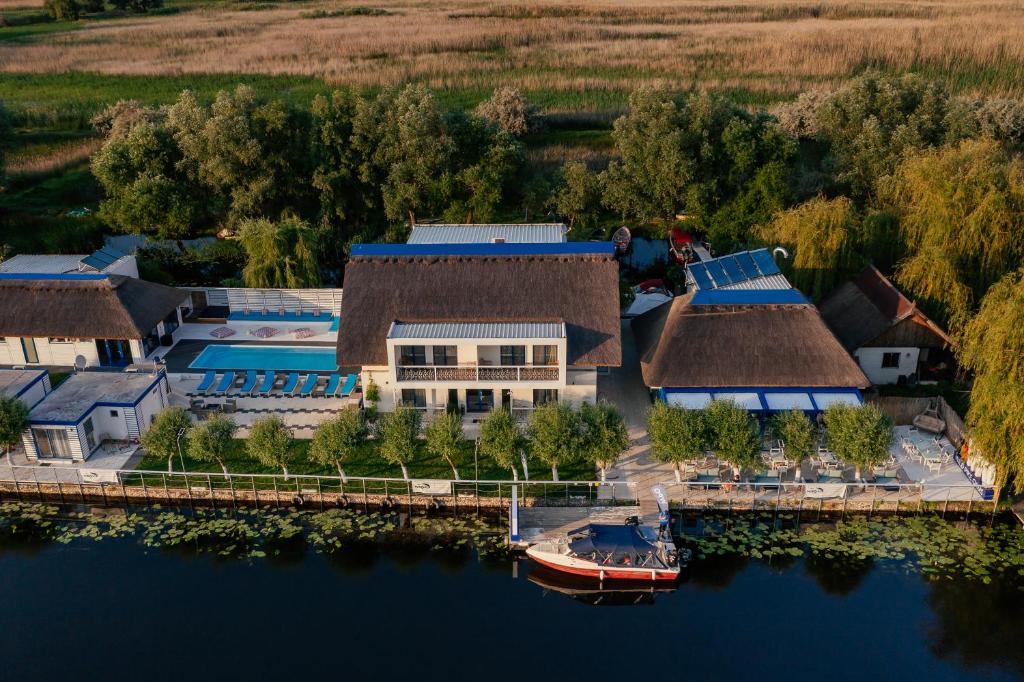 an aerial view of a house with a boat in the water at WPO - WILD PIKE OASIS in Caraorman