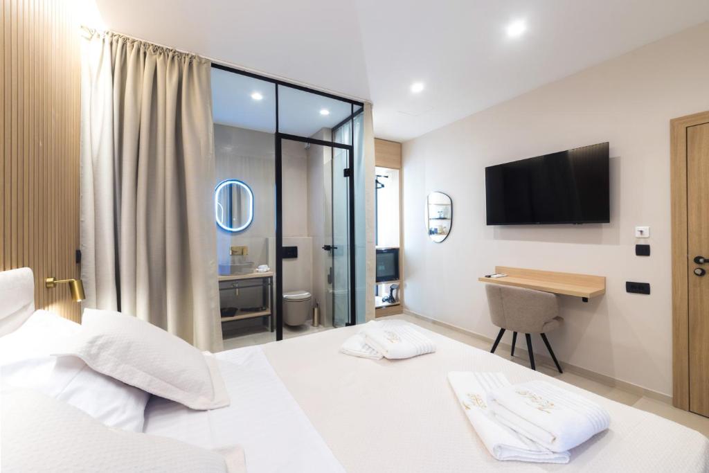Postel nebo postele na pokoji v ubytování Tonio Rooms