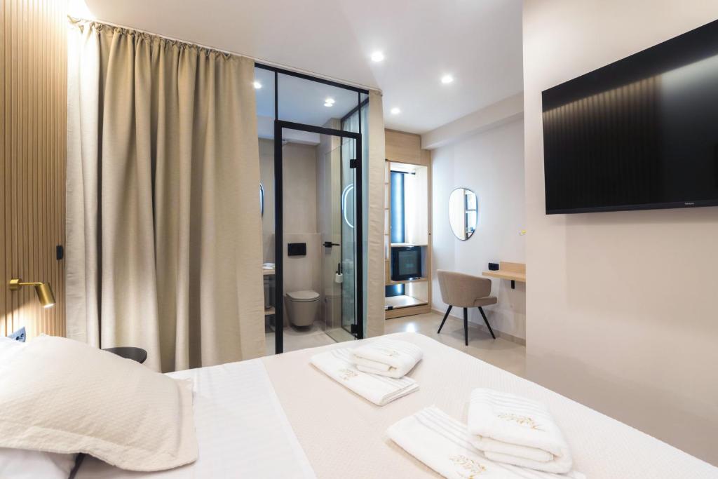 Postel nebo postele na pokoji v ubytování Tonio Rooms