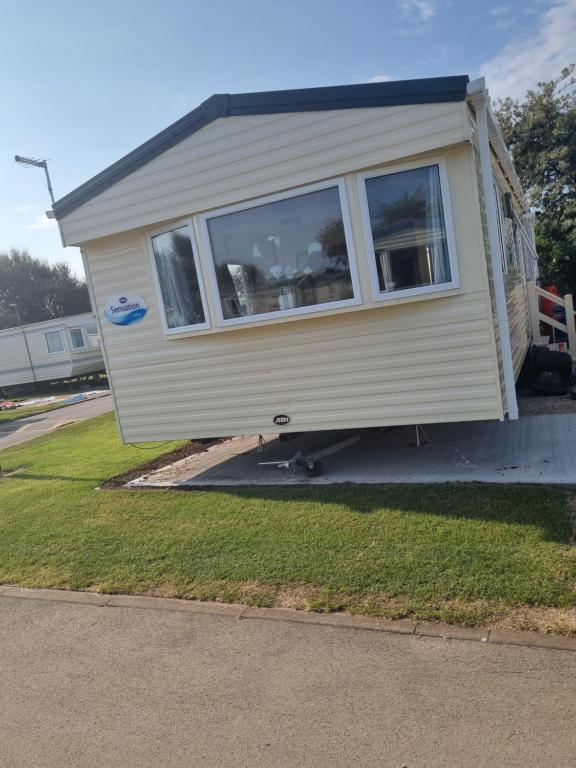 a mobile home is parked on the side of a road at Skipsea sands holidays in Ulrome