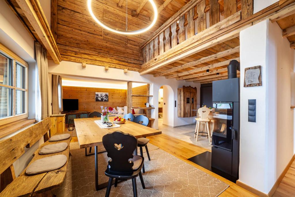 a kitchen and dining room with a wooden ceiling at Ferienhaus Mutlechnerhof in Caines