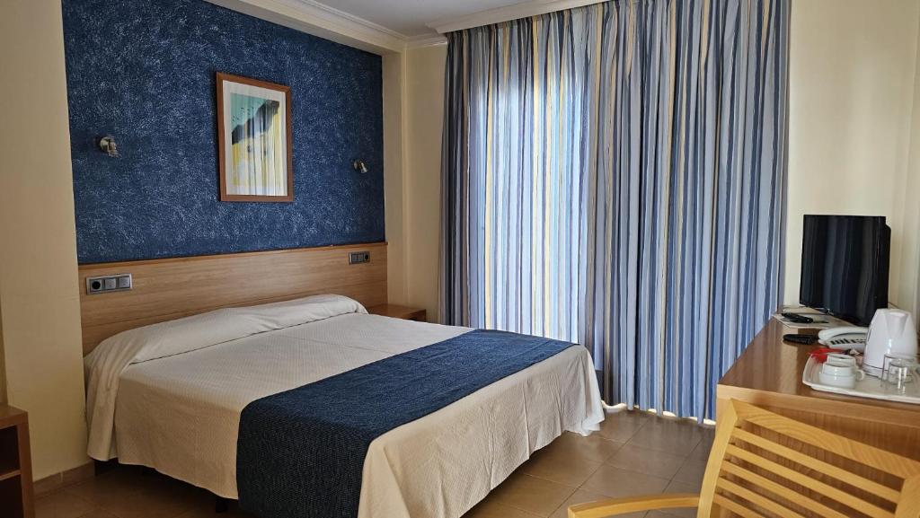 Postel nebo postele na pokoji v ubytování Hotel Punta del Cantal