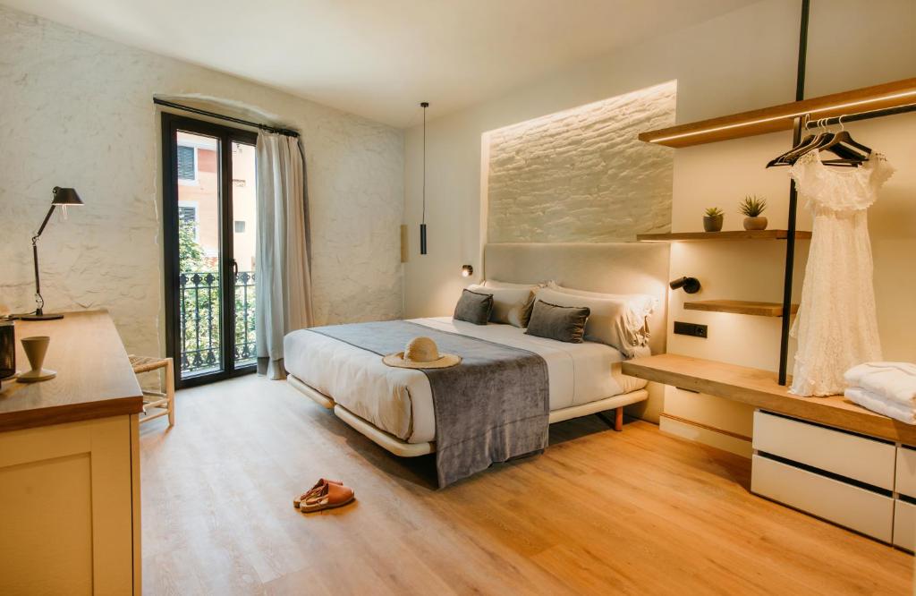 a large bedroom with a bed and a table at Casa Indiana Hotel Boutique in Blanes