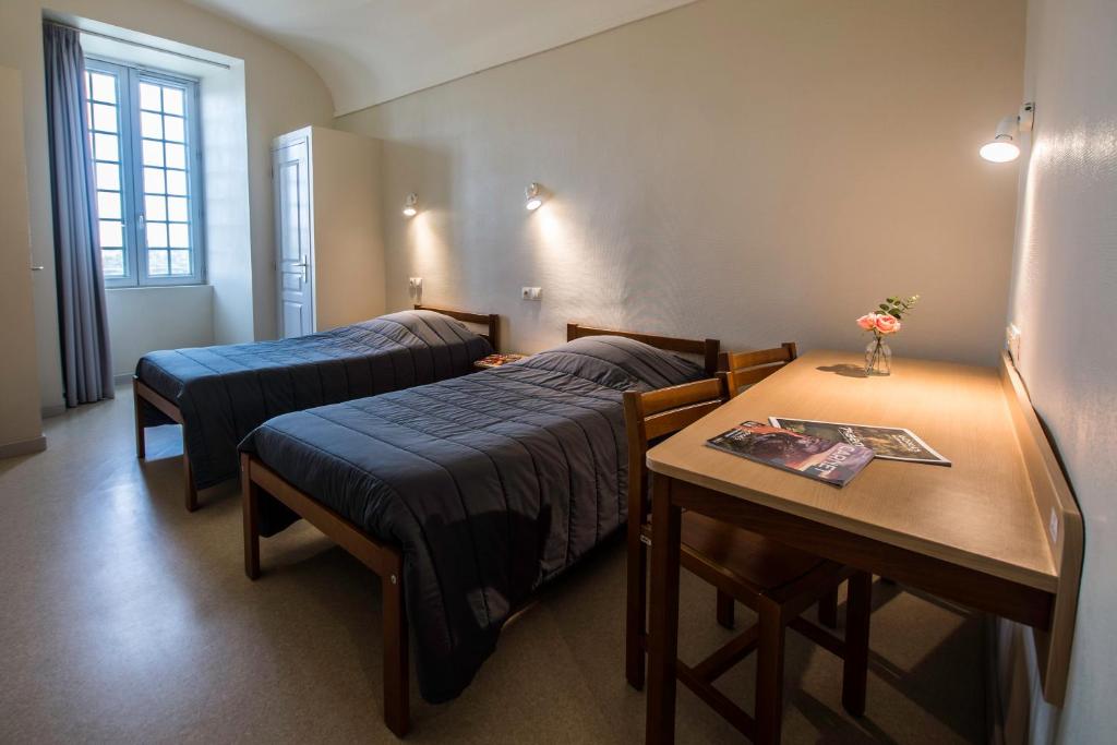Postel nebo postele na pokoji v ubytování HOSTELLERIE CHARLES de FOUCAULD