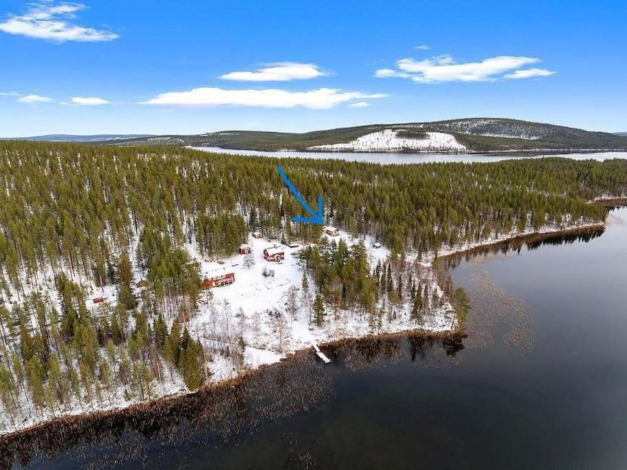 una isla en medio de un lago con árboles en Lakeside wilderness cabin en Jokkmokk