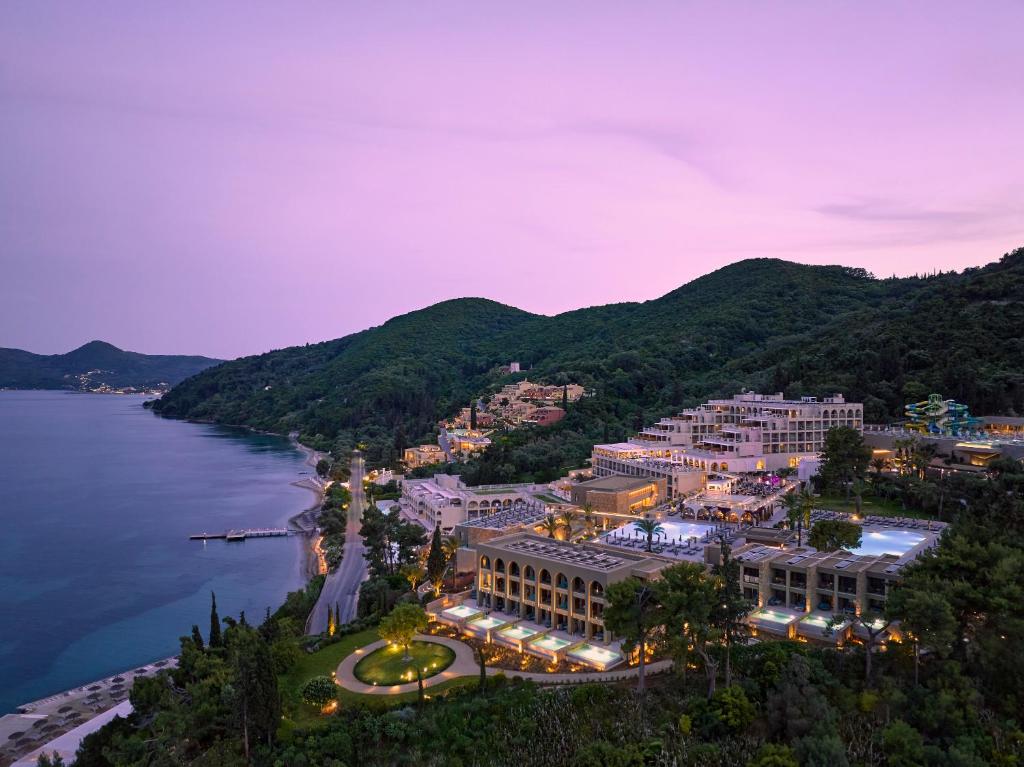 an aerial view of a resort on the water at night at MarBella, Mar-Bella Collection in Agios Ioannis Peristeron