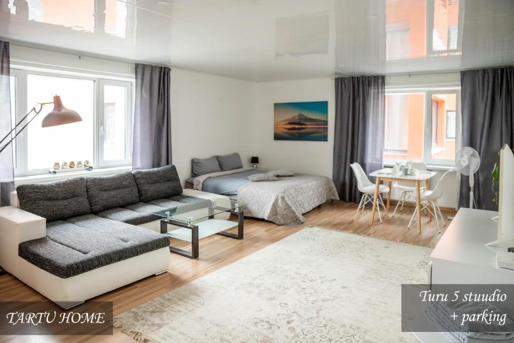 a living room with a couch and a bed at City Center Turu str apartments, parking, Tartu Home in Tartu