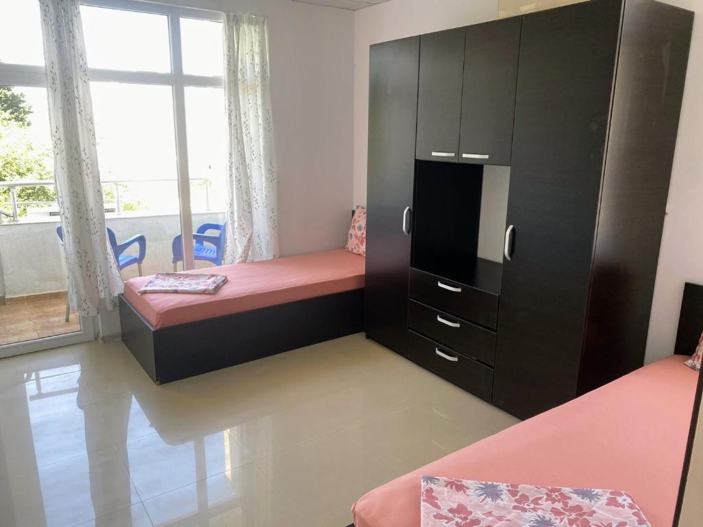 a bedroom with a bunk bed and a large window at VIP apart SVETLANA in Ravda