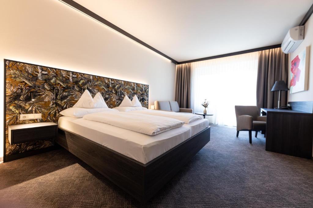 Postel nebo postele na pokoji v ubytování Thermalhotel Leitner