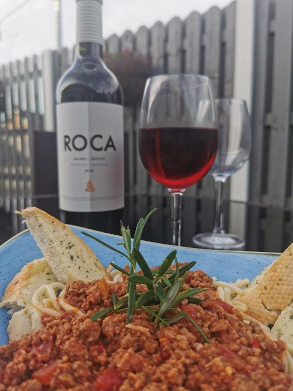 a plate of pasta and a glass of wine at Baginbun Lodge in Fethard on Sea