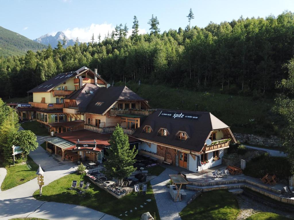 an aerial view of a large house in the mountains at Pension Tatrasport Zampa in Vysoke Tatry - Stary Smokovec