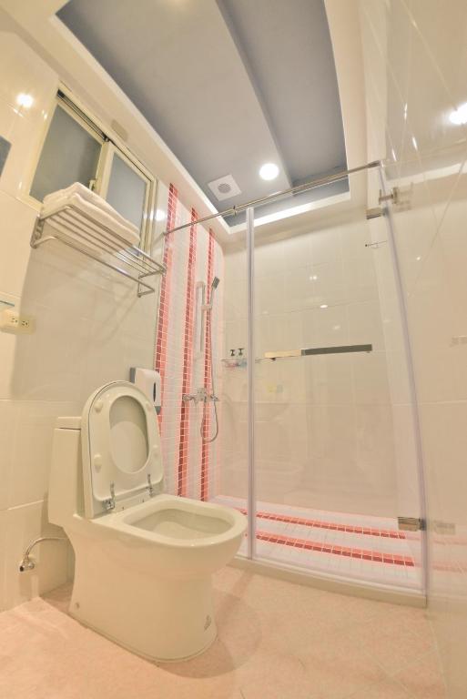 a bathroom with a toilet and a shower at Minsuku B&amp;B in Taitung City