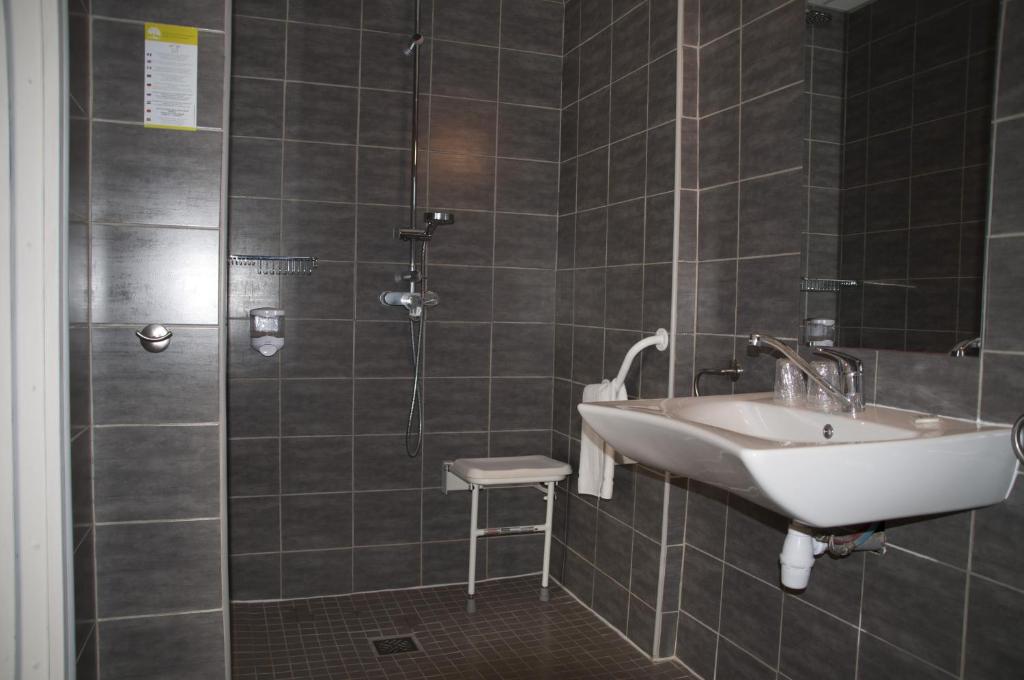 a bathroom with a sink and a shower at Hotel Bleu Azur in Argelès-sur-Mer