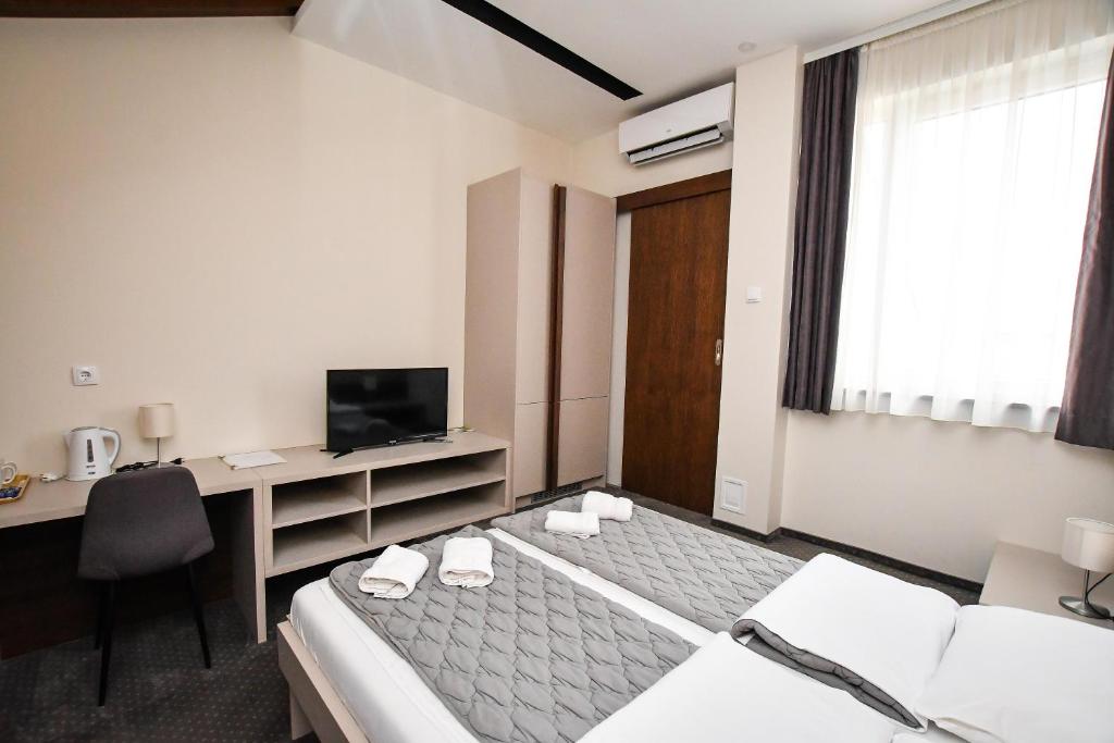 Postel nebo postele na pokoji v ubytování Atrijum Apartments and Rooms