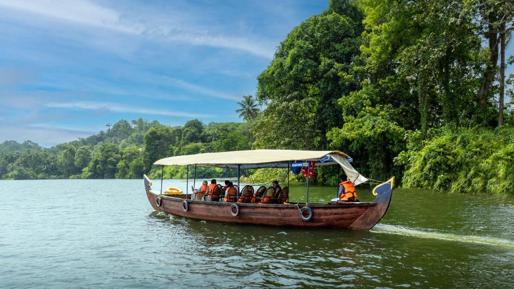 a group of people on a boat on the water at Munkudil Ayurveda & Yoga Retreat in Kuttampuzha