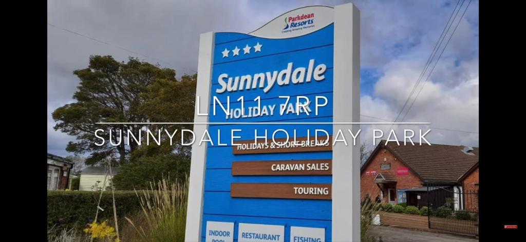 a sign for a swimming holiday park in a yard at 27 Rickardos Holiday Lets 3-Bed Caravan near Mablethorpe in Saltfleet