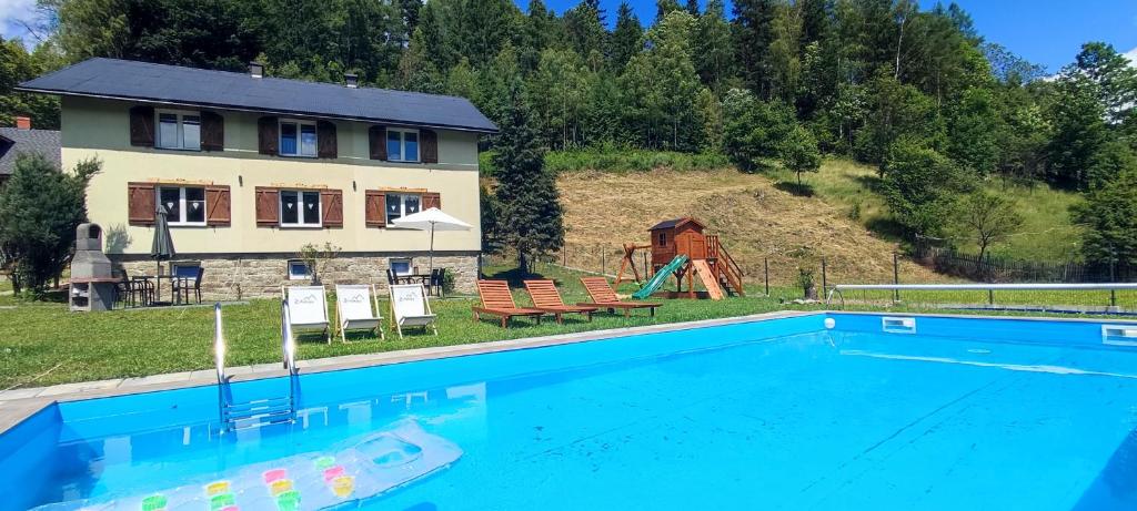 a house with a swimming pool in front of a house at 2chałupy - apartamenty w Soli in Sól
