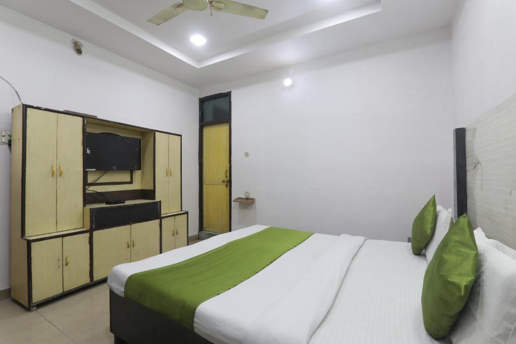 a bedroom with a large bed and a television at Hotel Dayal in Lucknow