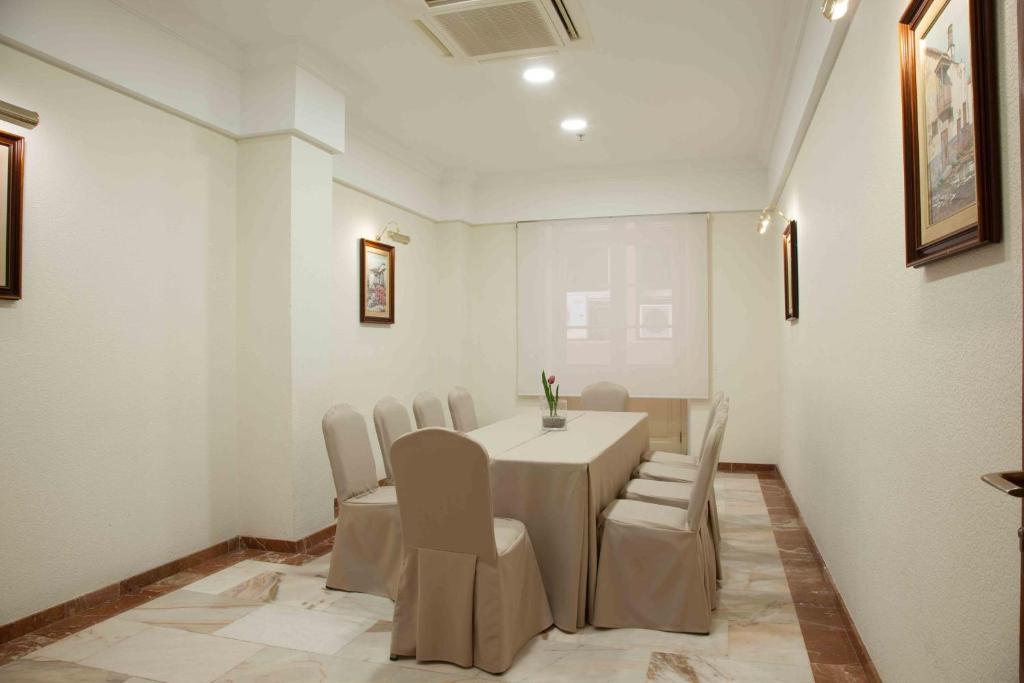 a white room with a table and chairs in it at Hotel Principe Paz in Santa Cruz de Tenerife