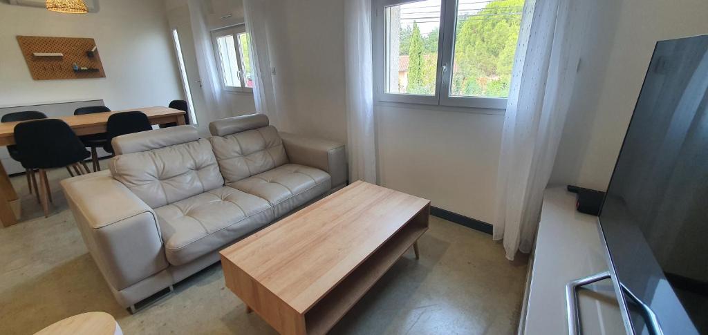 a living room with a couch and a table at Appartement 2 chambres in Le Born
