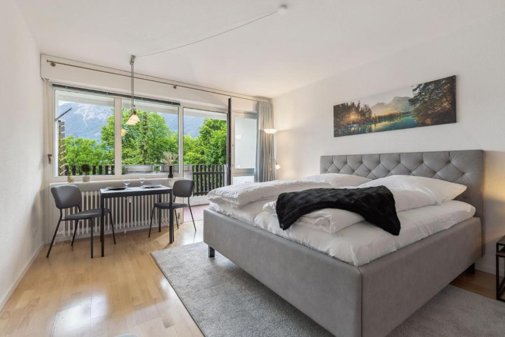 a bedroom with a bed and a table and chairs at Apartment BERGBLICK in Bad Reichenhall
