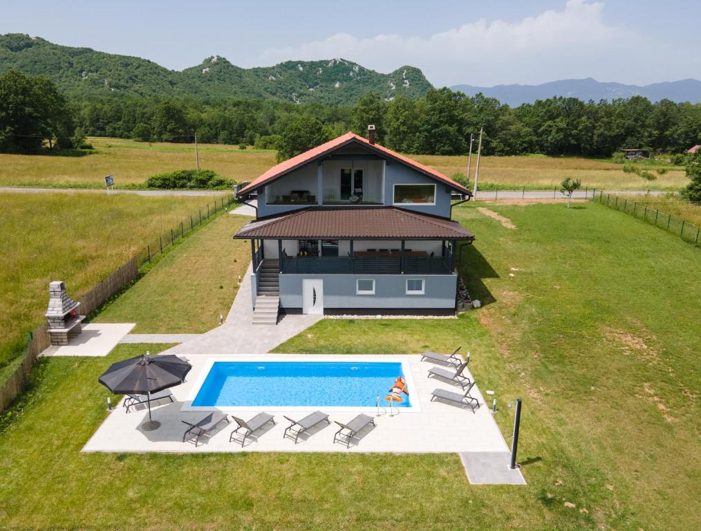 an aerial view of a house with a swimming pool at Plum house - villa with pool in Gospić
