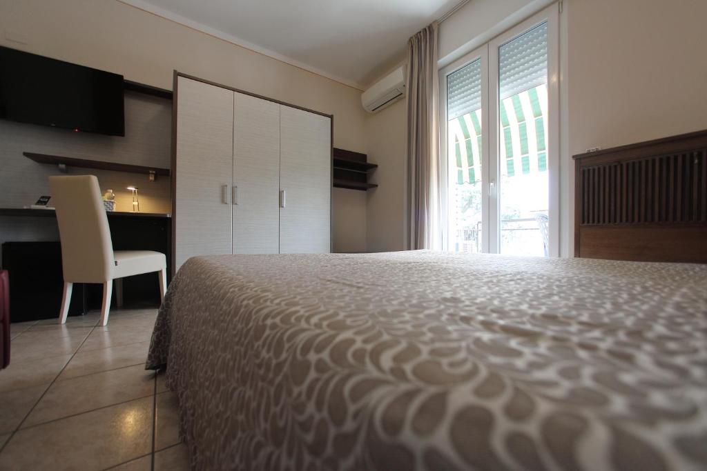 Ένα ή περισσότερα κρεβάτια σε δωμάτιο στο Hotel Campanello