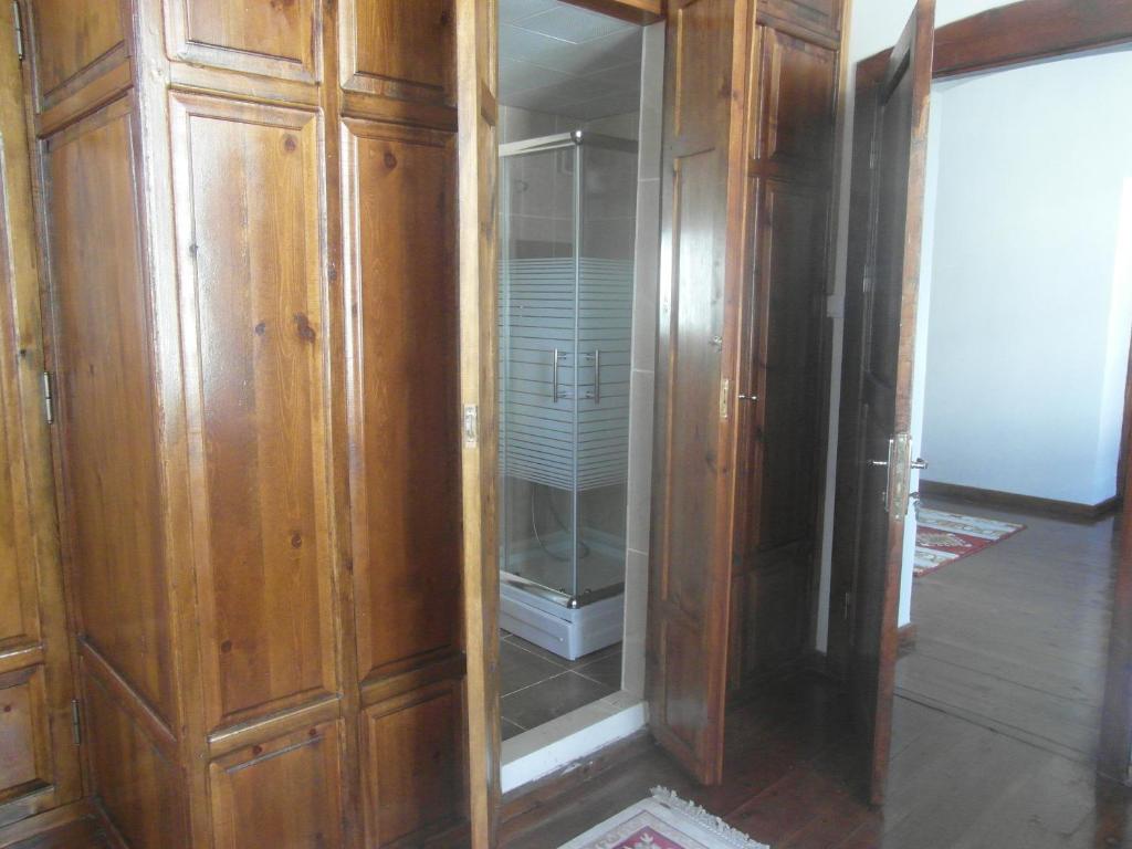 a wooden cabinet with a glass door in a room at Frig Evi in Sabuncu