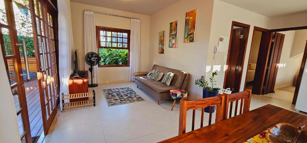 a living room with a couch and a table at Flat - SERRA E MAR - Paraty in Paraty