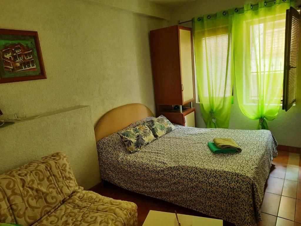 - une chambre avec un lit et une chaise dans l'établissement Apartments Stars, à Ohrid