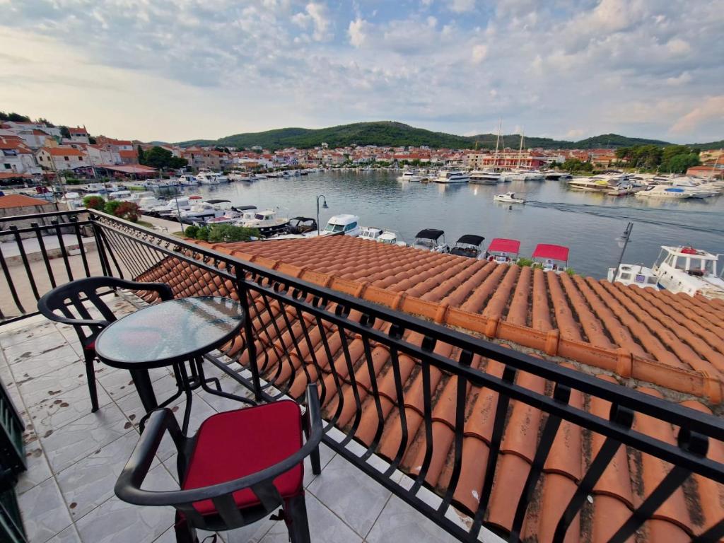 a balcony with a table and chairs and a harbor at Old town - AP3 in Tribunj