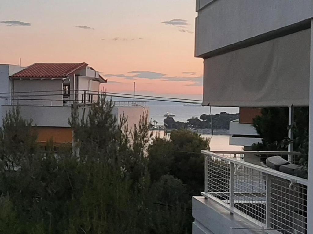 a view of the ocean from the balcony of a house at Το σπίτι του καπετάνιου στη Βουλιαγμένη in Athens