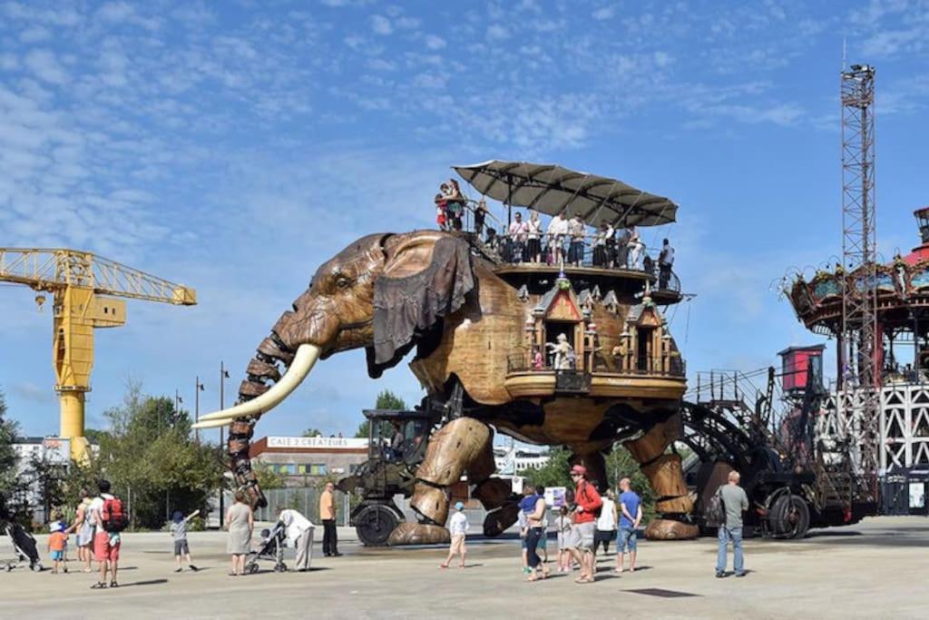 a group of people riding on top of an elephant statue at Un jardin en ville in Nantes
