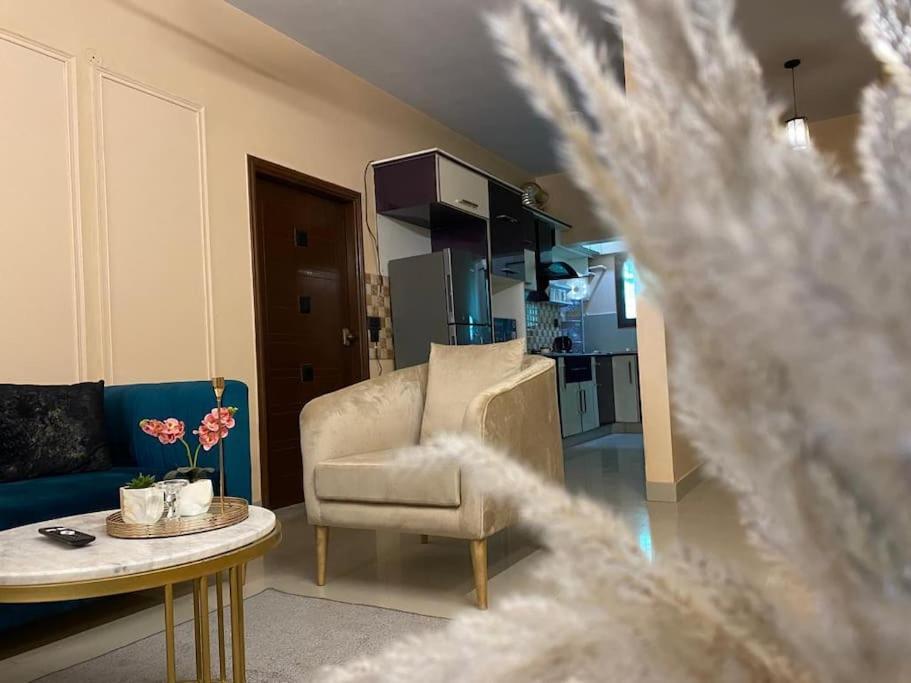 a living room with a couch and a table at 3 Bed DD Luxury Apt SMCHS in Karachi