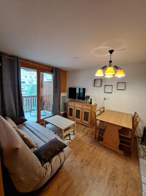 un salon avec un canapé et une table dans l'établissement Appartement Orcières Merlette, à Orcières