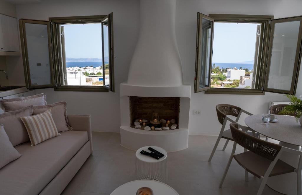a living room with a couch and a fireplace at Paros Breeze Luxury Villa in Drios